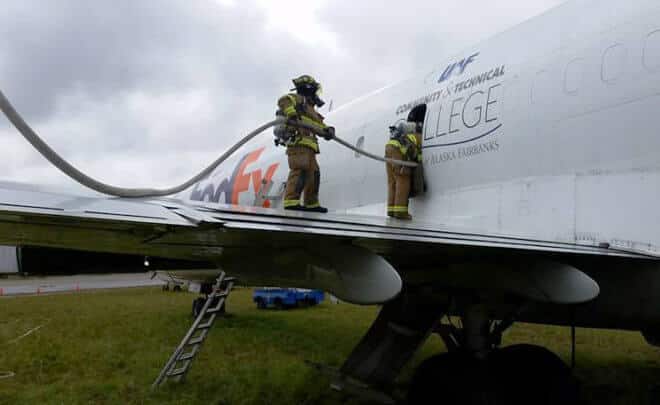 Fairbanks International Airport fire rescue personnel respond to a simulated aircraft fire for a state certification test Sept. 19. They used the 727 jet owned by the University of Alaska Fairbanks Community and Technical College. UAF photo by Kevin Alexander.