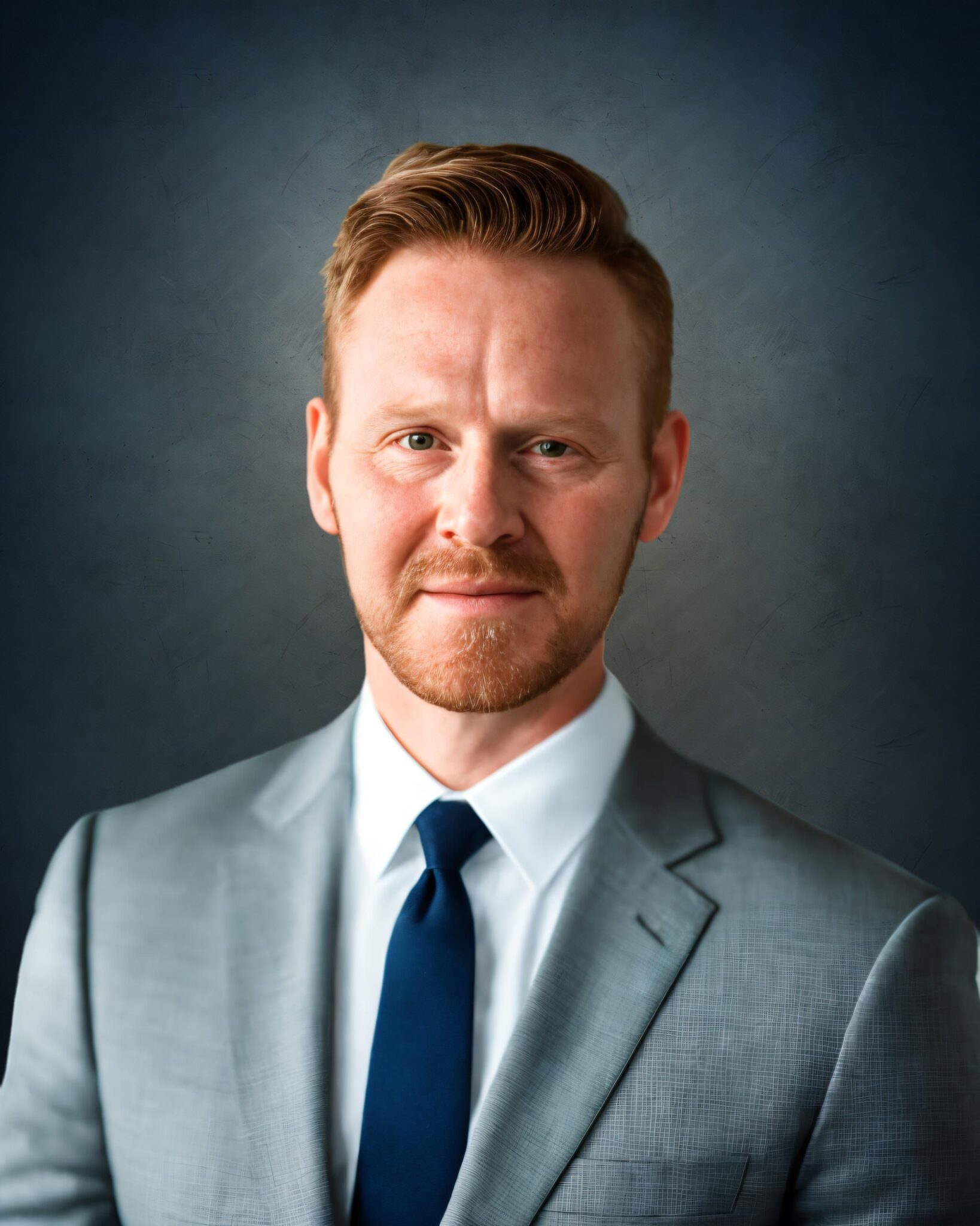 Headshot of UAF CTC dean candidate Carl Bishop, wearing a grey suit and navy tie