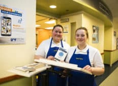 Two female culinary students smile at the camera