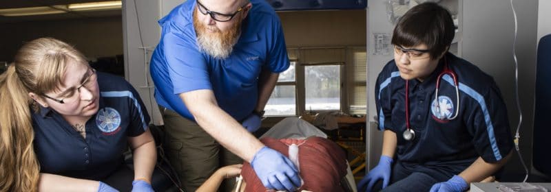 Paramedic instructor teaches two students